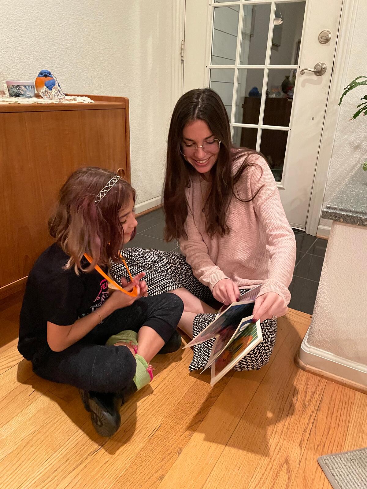 Alyssa Pitts reading a book with a child during an in-home speech therapy session in San Diego