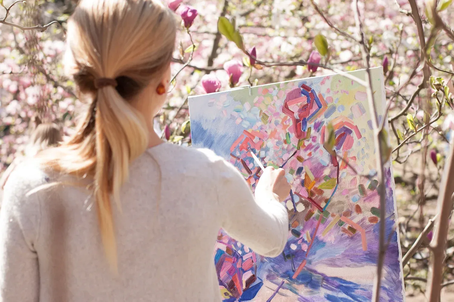 Student painting a cherry blossom tree to practice her words during speech therapy