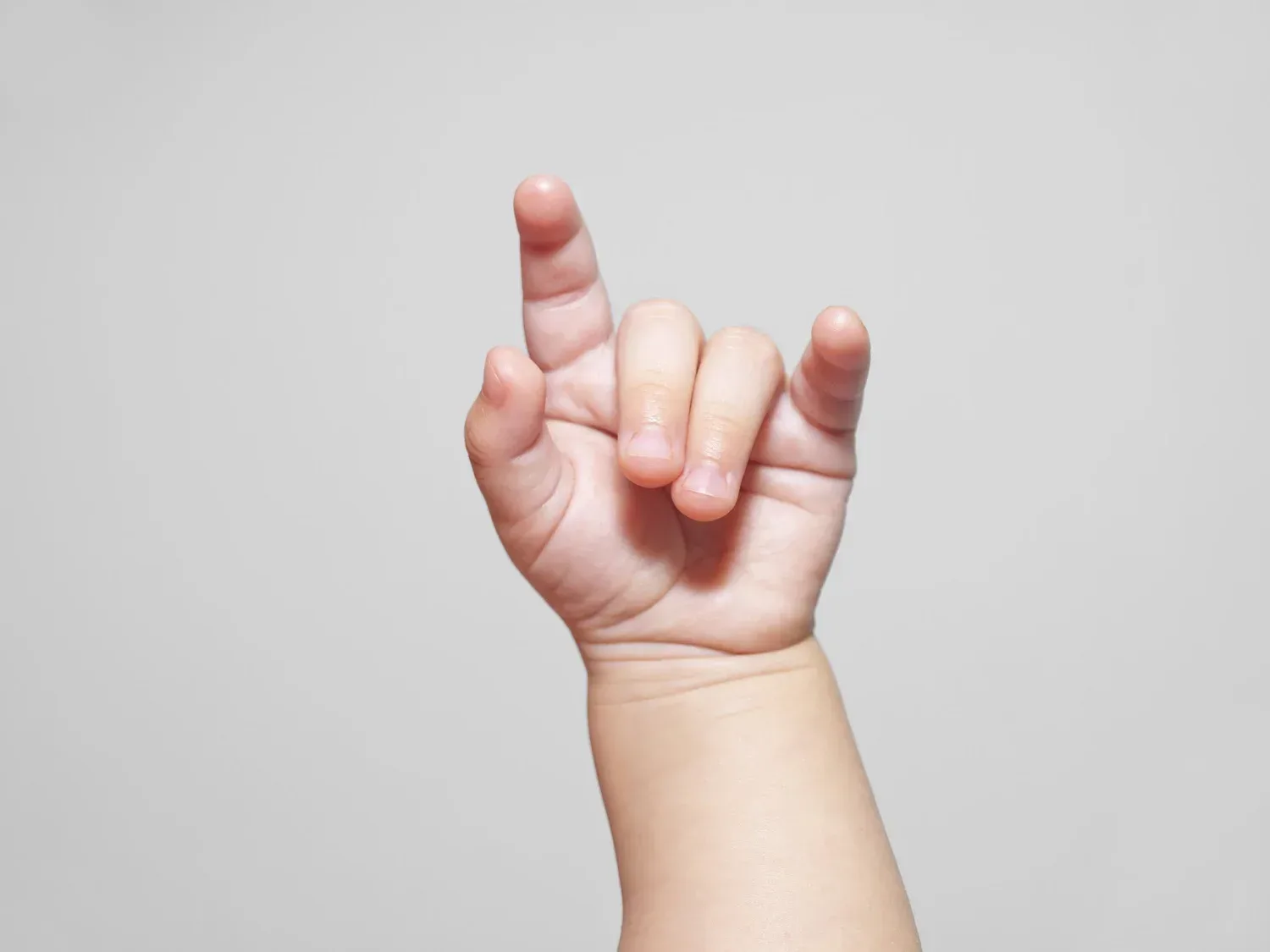 Hand showing baby sign language for I love you during speech therapy
