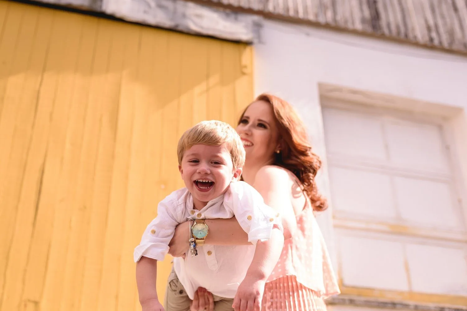 Mom carrying her child having fun in speech therapy