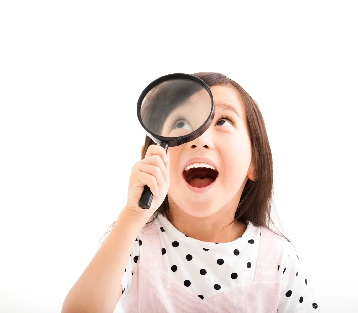 Child looking through a magnifying glass at research in the field of speech language pathology